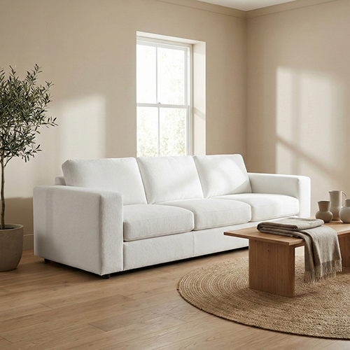 White sofa in a bright room lit by soft window light